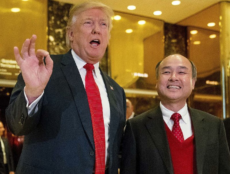 President-elect Donald Trump appears with tech billionaire Masayoshi Son at Trump Tower in New York on Dec. 6 after Son pledged a $50 billion investment in the U.S. by his SoftBank Group that would result in 50,000 jobs. 