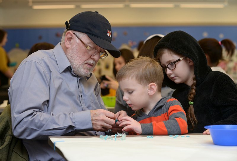 Kevin Gore (from left), visiting from Manchester, England, helps his grandchildren Tim Gore, 4, and Rose Gore, 8, of Centerton make bead icicles during Winter Break Wonders at Crystal Bridges Museum of American Art in Bentonville in this Thursday, Dec. 29, 2016, file photo.