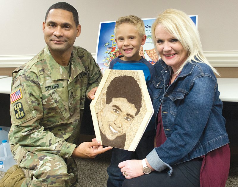 From left, Rodney, Will and Kristy Cotillier hold the florograph of Evan Cotillier that will be on the Donate Life Rose Parade float Monday.