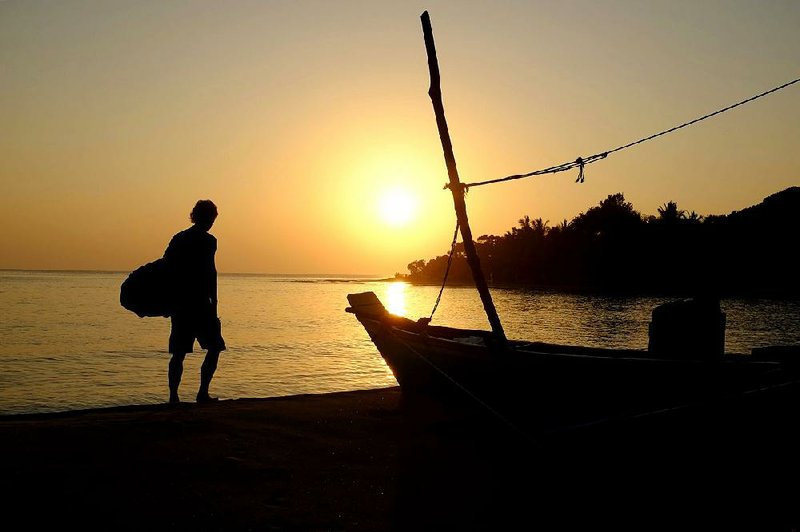 A surfer sets off for a dawn start at Main Point, one of Arugam Bay’s most famous surf-breaks in Sri Lanka. 