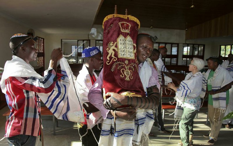 Israel Siriri (center) carries the Torah during prayers at the new Stern Synagogue in Mbale, in eastern Uganda.