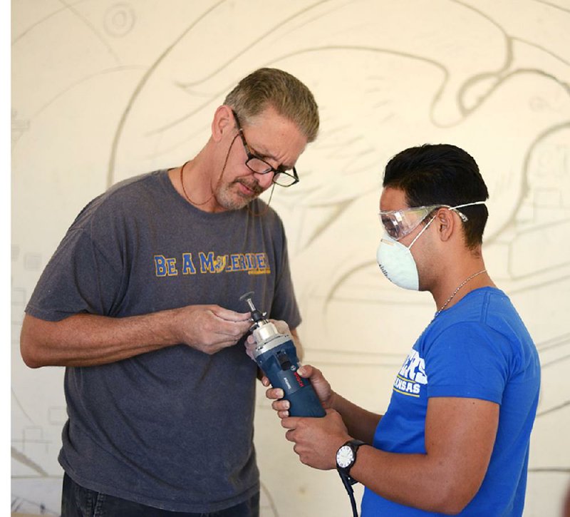 Southern Arkansas University art professor Steve Ochs works with a Cuban student on an art project at the University of Artemisa in Cuba.