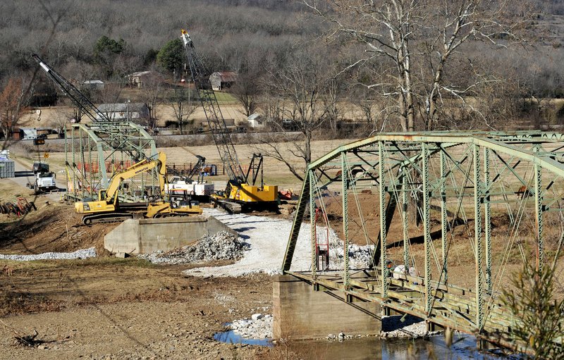 Work continues Friday at the site of the Woolsey Bridge south of West Fork.
