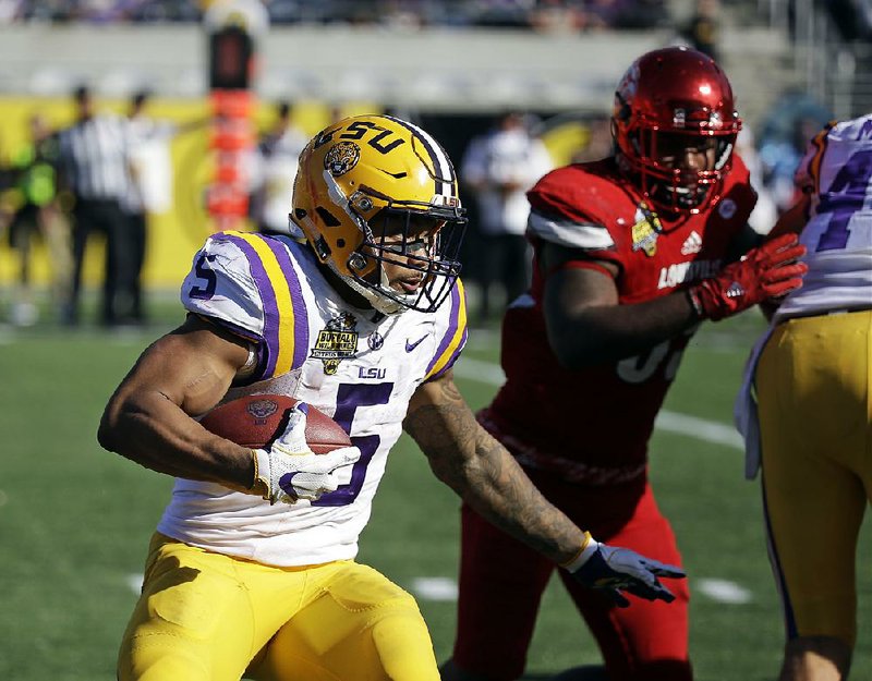 LSU running back Derrius Guice (5) ran for 138 yards and 1 touchdown while making 3 catches for 11 yards and another touchdown to lead the No. 20 Tigers to a 29-9 victory over No. 13 Louisville on Saturday at the Citrus Bowl in Orlando, Fla. 
