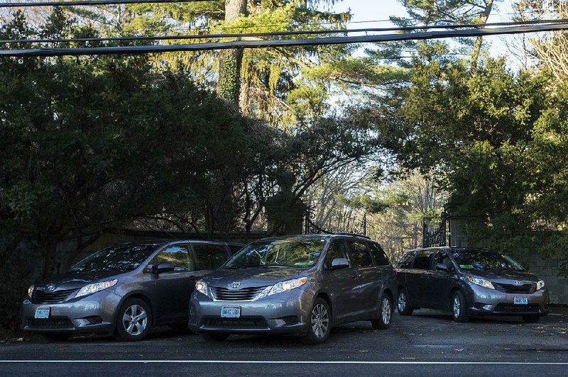 Cars with diplomatic license plates leave a Russian diplomatic compound Friday near Glen Cove, N.Y., on Long Island. 