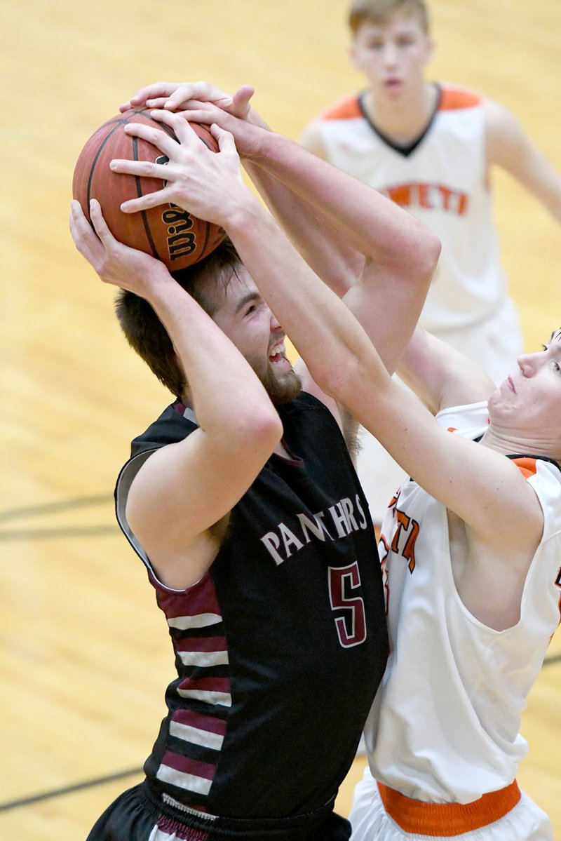 Bud Sullins/Special to Siloam Sunday Siloam Springs senior Josh Hunt battles a Coweta (Okla.) defender for the ball during Thursday&#8217;s game in the Siloam Springs Holiday Classic. Coweta defeated Siloam Springs 55-46.