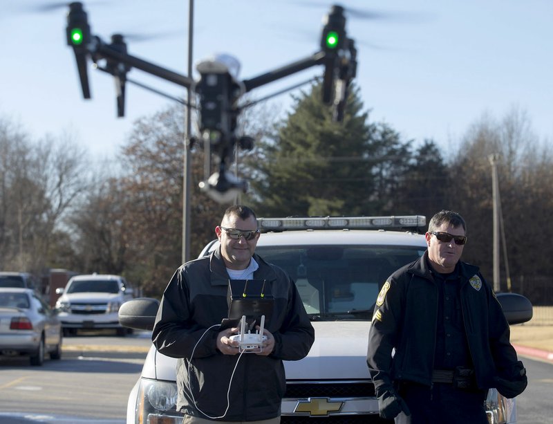 Rogers Police Sgt. Miles Mason (right) watches as Capt. Jarod Mason flies the department’s DJI Inspire 1 v2.0 quadcopter on Dec. 19 behind the Rogers Police Department.