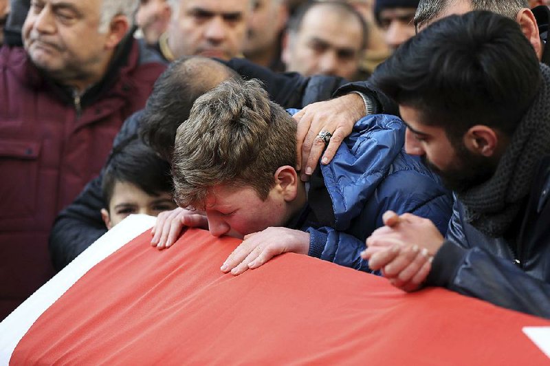 Family and friends mourn Sunday as they attend funeral prayers for Ayhan Akin, one of 39 people killed at a nightclub in Istanbul.