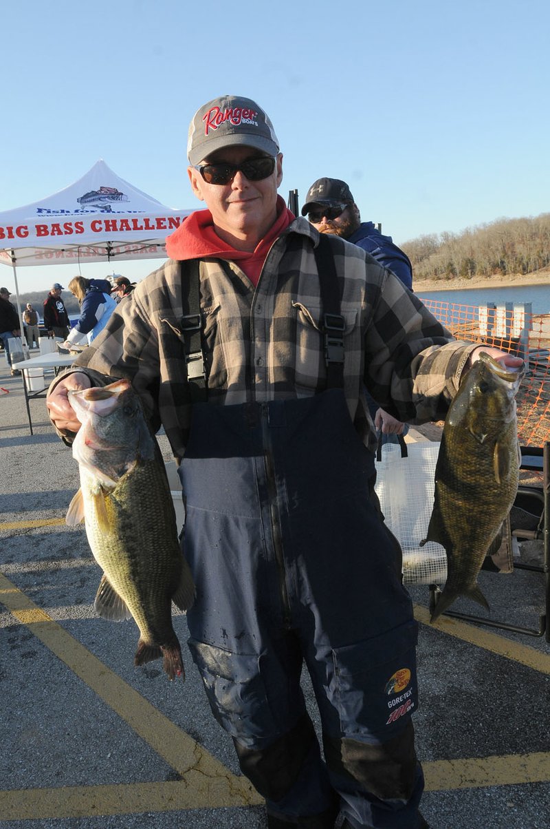 Robbie Dodson of Harrison shows two of the bass he and his dad, Robert Dodson, caught Sunday to win the annual Polar Bear Memorial Bass Tournament at Beaver Lake.