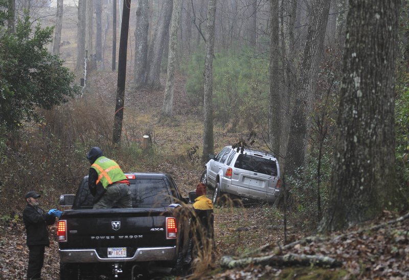 Authorities work to recover an SUV that had been stolen earlier Monday from a Little Rock gas station.