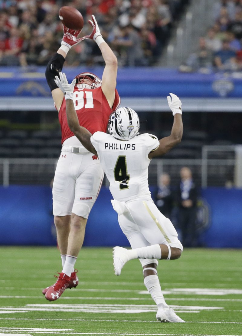 Wisconsin tight end Troy Fumagalli (81) catches a pass against Western Michigan cornerback Darius Phillips (4) during the fourth quarter of the Cotton Bowl NCAA college football game Monday, Jan. 2, 2017, in Arlington, Texas.