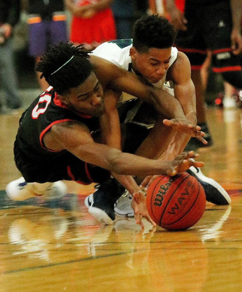 Maumelle’s Mike Fuller (left) and Little Rock Christian’s Mykal Moore scramble for a loose ball Tuesday during the Hornets’ 80-72 victory over the Warriors.