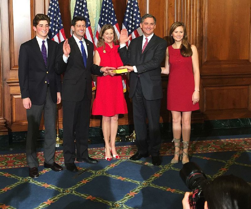 House Speaker Paul Ryan (second from left) poses with Rep. French Hill of Little Rock after the official swearing-in of the 115th Congress in Washington on Tuesday. Hill’s wife, Martha, stands between the two lawmakers. The Hills’ son Payne is at left and daughter Liza at right.