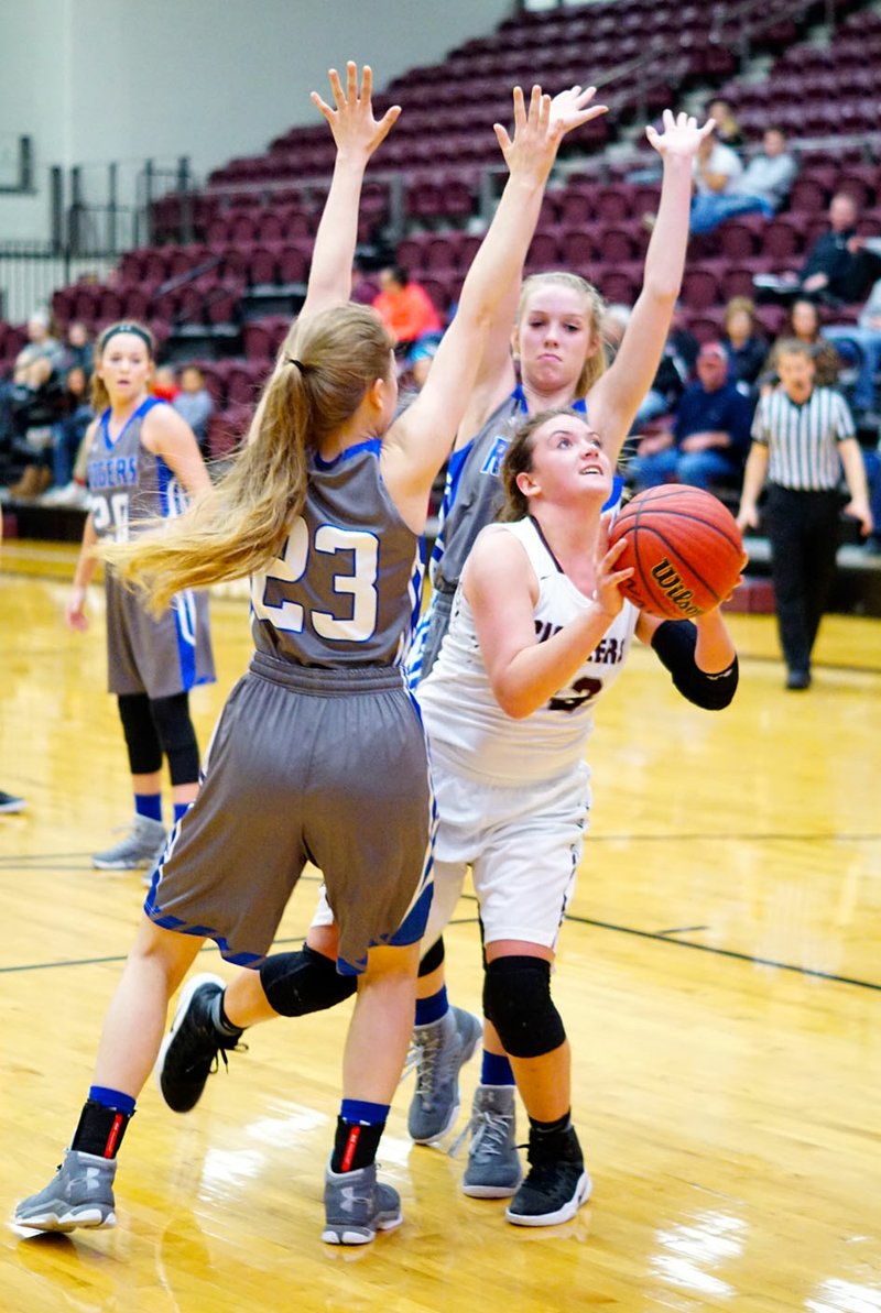 Photo by Randy Moll Gentry&#8217;s Haley Hays looks to shoot for two under the basket in the Siloam Springs Holiday Classic game against Rogers at Siloam Springs High School on Dec. 29, 2016.