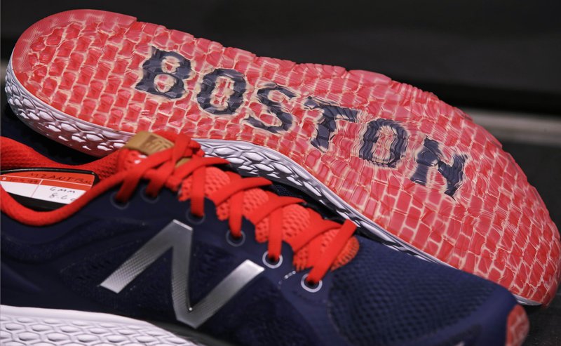 In this Wednesday, Dec. 28, 2016 photograph, the word "Boston" accents the sole of the New Balance Zante v2 shoe on display at the storefront of the world headquarters of New Balance in the Brighton neighborhood of Boston. 