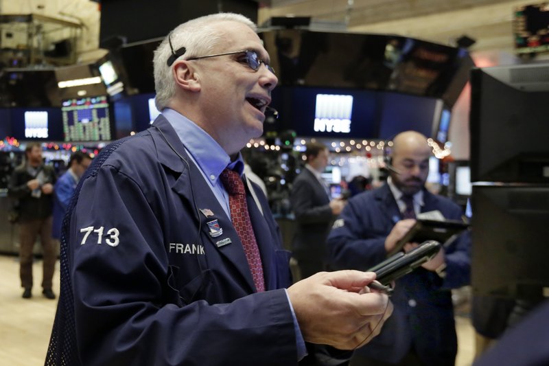 Trader Frank O'Connell, left, works on the floor of the New York Stock Exchange, Tuesday, Jan. 3, 2017. 