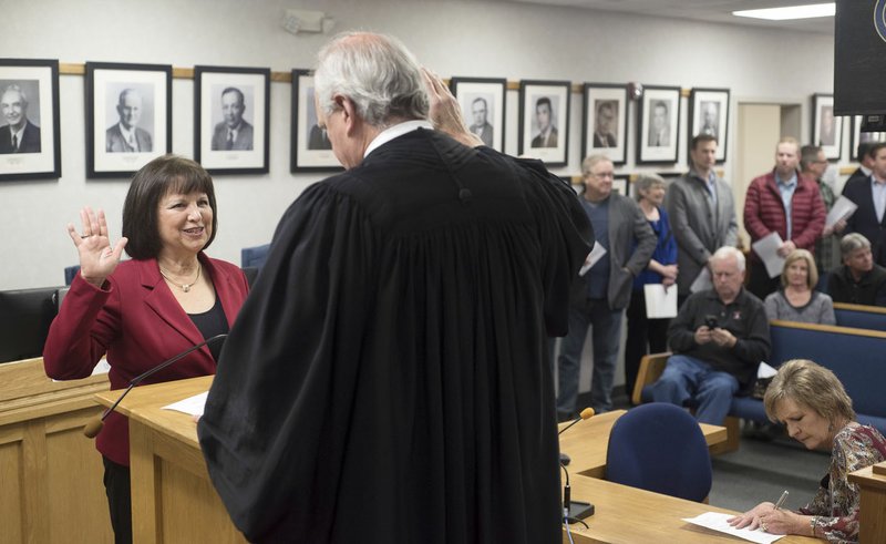 NWA Democrat-Gazette/J.T. WAMPLER Debra Hobbs of Rogers is sworn in Tuesday as a board member for the Northwest Arkansas Community College by Circuit Judge Doug Schrantz. Hobbs is a former member of the Arkansas House of Representatives, a former Benton County Quorum Court member, former school counselor and teacher and a former secretary of the Benton County Sunshine School Board.