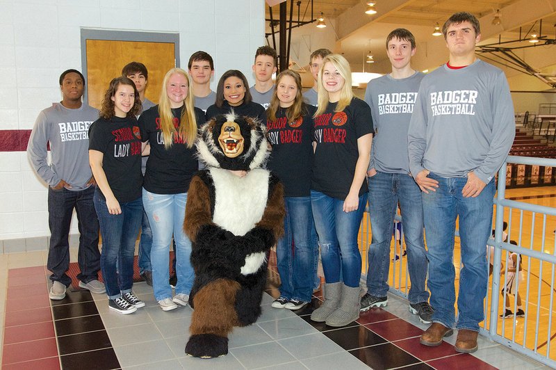 Blaine Burge, in the Beebe Badger mascot uniform, poses with, front row from left, Allie Lane, Shea Holland, Hannah McGhee, Taylor Harris and Hannah Camp; and back row, Tyler Long, Grant Brown, John Windle, KJ O’Neill, Landon Davis, Bradley Worthington and Grant Jackson. The students are basketball players at Beebe High School and will participate in the fourth annual Badger Booster Club Alumni Basketball Game on Jan. 21.