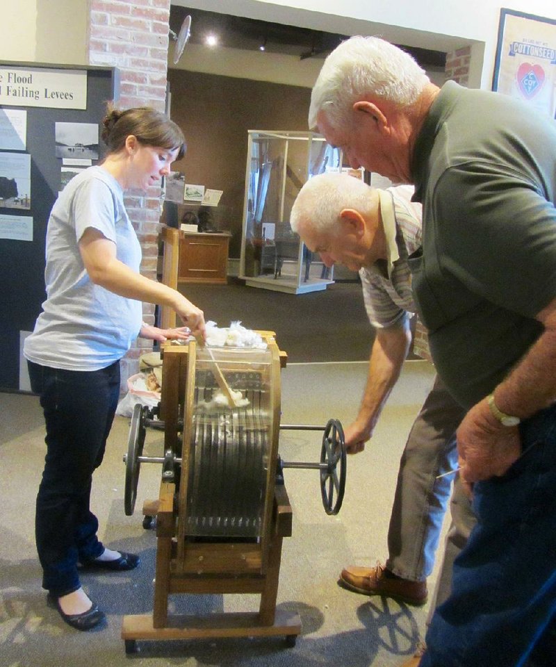 Visitors can operate a scale model of a cotton gin at Plantation Agriculture Museum in Scott. 