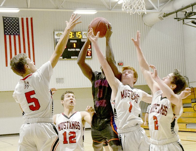 Photo by Rick Peck Cedar Ridge&#x2019;s Daylon Gant grabs a rebound despite being surrounded by four McDonald County Mustangs &#x2014; Boston Dowd (5), Cole DelosSantos (12), Blake Gravette (1) and Rustan Lett (2). The Mustangs beat the Timber Wolves 51-42 in the final round of last week&#x2019;s Neosho Holiday Classic for their only win in four tournament games.