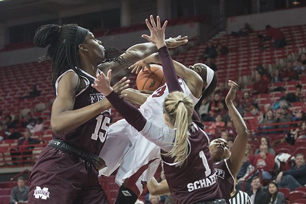 Arkansas' Malica Monk gets her shot blocked by Mississippi State's Teaira McCowen, (from left) Blair Schaefer and Morgan William on Thursday, Jan. 5, 2017, at Bud Walton Arena in Fayetteville.