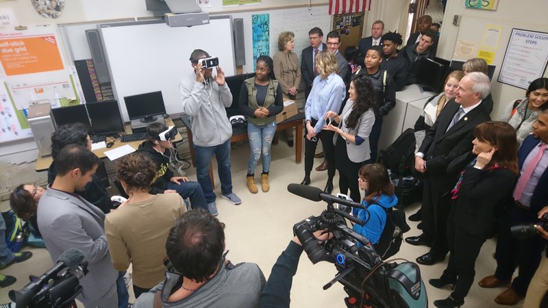 Gov. Asa Hutchinson and Erin Egan, vice president of U.S. public policy for Facebook, watch as a Little Rock Central High School student tries a virtual reality headset on Thursday, Jan. 5, 2017.