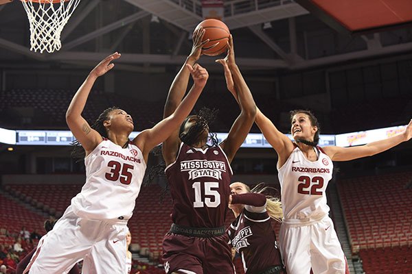 Arkansas' Alecia Cooley (35) and Bailey Zimmerman (22) battle for a rebound against Mississippi State's Teaira McCowan during a game Thursday, Jan. 5, 2017, in Fayetteville. 