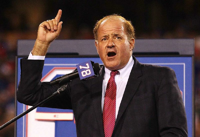 FILE - In this Sept. 15, 2016, file photo, Chris Berman introduces former Buffalo Bills Hall of Fame defensive end Bruce Smith during his jersey retirement ceremony at halftime of an NFL football game, in Orchard Park, N.Y. Berman isn't disappearing from in front of the cameras or from behind the microphones.
He's simply stepping to the side a bit. The longtime ESPN fixture is giving up his regular on-air NFL and baseball spots for a new role at the network.(AP Photo/Bill Wippert, File)
