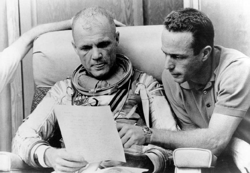 Prime astronaut John Glenn and backup pilot Scott Carpenter check over notes after a simulated flight before the Mercury-Atlas 6 mission. The “Heroes and Legends” exhibit pays tribute to NASA heroes.