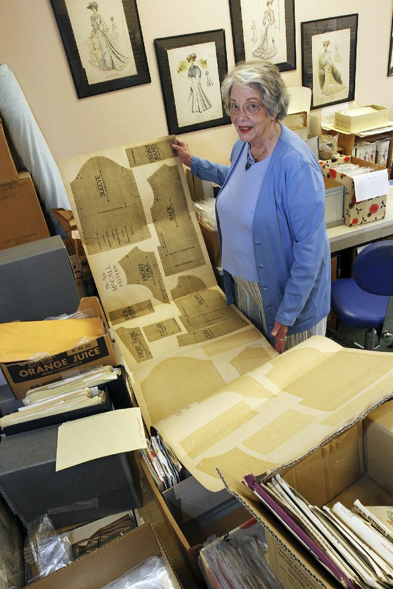 Joy Spanabel Emery, professor emerita and curator of the University of Rhode Island’s commercial pattern archive, displays a donated sewing pattern in her office on campus in South Kingstown, R.I.