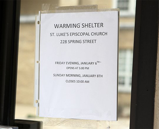 The Sentinel-Record/Richard Rasmussen SHELTER: A sign on the church office door at St Luke's Episcopal Church announces the opening of a warming shelter today at 5 p.m.