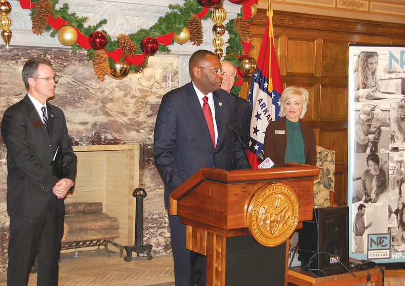 Henderson State University President Glen Jones, center, speaks during a press conference Wednesday at the state Capitol in Little Rock to announce the formation of the Southern Arkansas Regional Alliance. Standing behind Jones are Gov. Asa Hutchinson and Maria Markham, director of the Arkansas Department of Higher Education. Also shown is National Park College President John Hogan, left.  