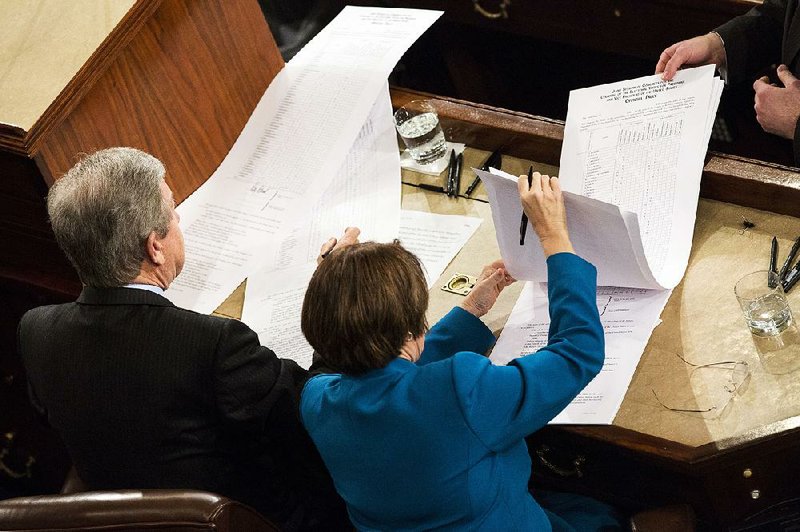 Sen. Roy Blunt, R-Mo., and Sen. Amy Klobuchar, D-Minn., sign off on the official electoral vote tally after Friday’s joint session of Congress.