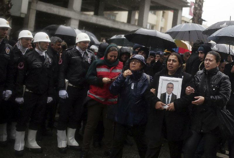 A funeral procession takes place Friday in Izmir, Turkey, for police officer Fethi Sekin, who was killed in an attack Thursday.