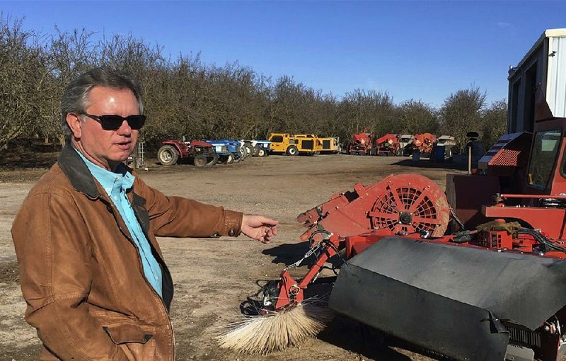 Farmer Kevin Herman of Madera, Calif., shows off one of the almond sweepers he bought out of concern that he wouldn’t have enough help at the next harvest.