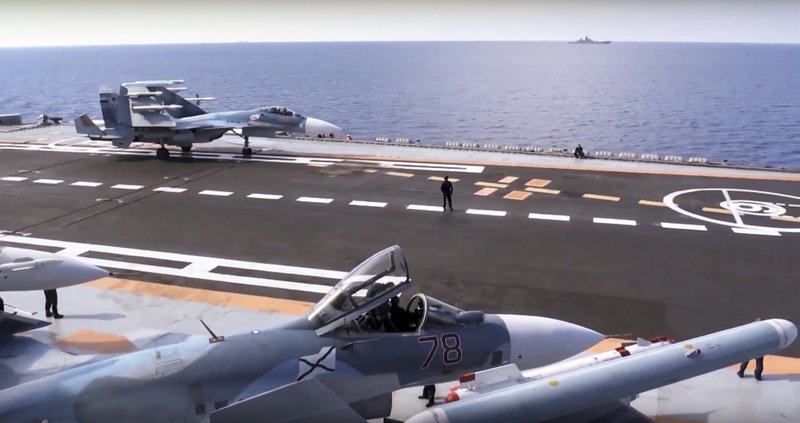 In this file photo made from the footage taken from Russian Defense Ministry website on Nov. 15, Russian Su-33 fighter jets stand on the flght deck of the Admiral Kuznetsov aircraft carrier in the eastern Mediterranean Sea.