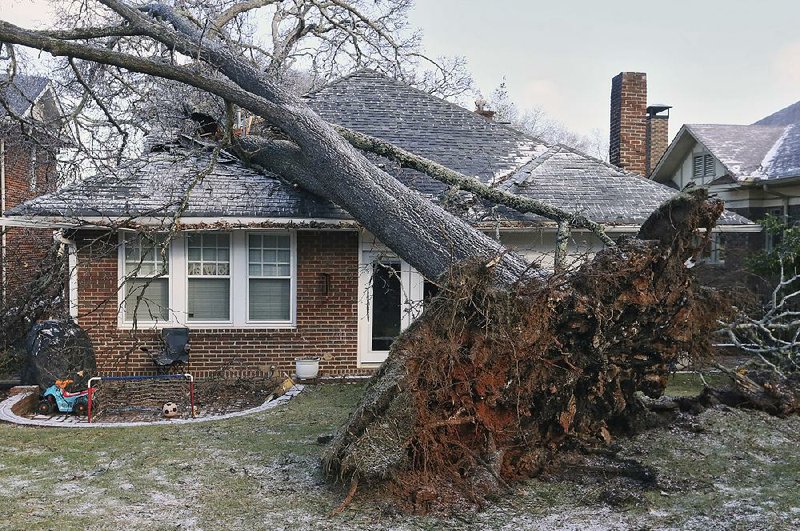 Icy weather caused a tree to topple onto a house in Atlanta early Saturday, trapping a child inside. The boy had to be rescued through a window. Residents in parts of Georgia had expected a couple of inches of snow but instead woke up Saturday to find coats of ice. 