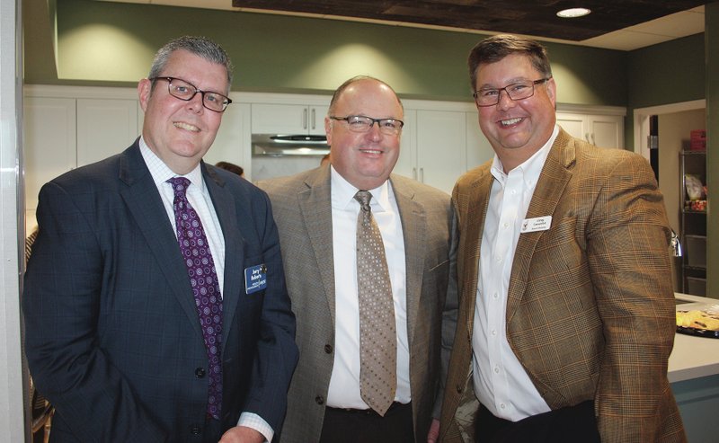 Jerry Roberts (from left), Bill Mathews and Greg Lancelot celebrate the opening of the new Ronald McDonald House.
