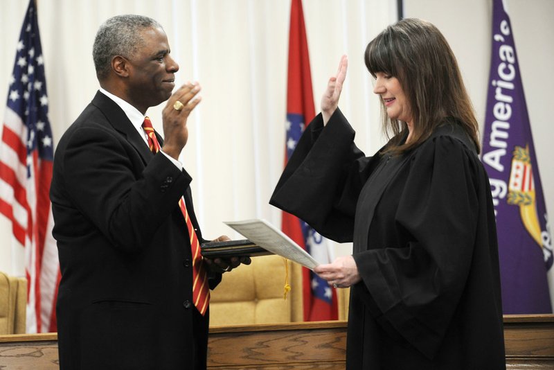 NWA Democrat-Gazette/ANDY SHUPE Washington County Judge Joseph Wood is sworn in Tuesda by Circuit Judge Stacey Zimmerman during a ceremony in the Quorum Courtroom at the Washington County Courthouse in Fayetteville. Nearly 20 county officials were sworn in Tuesday. Visit nwadg.com/photos to see more photographs from the ceremony.