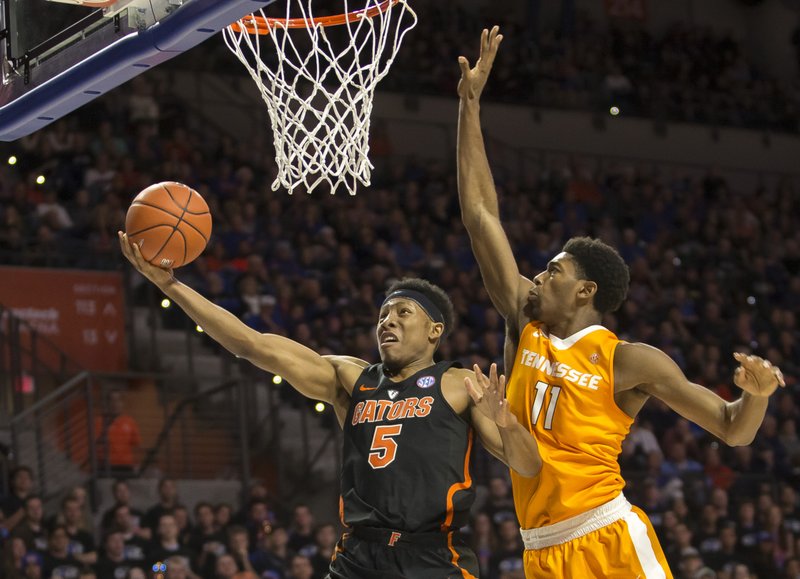 Florida guard KeVaughn Allen (5) shoots a layup past Tennessee forward Kyle Alexander (11) during the first half of an NCAA college basketball game in Gainesville, Fla., Saturday, Jan. 7, 2017. 