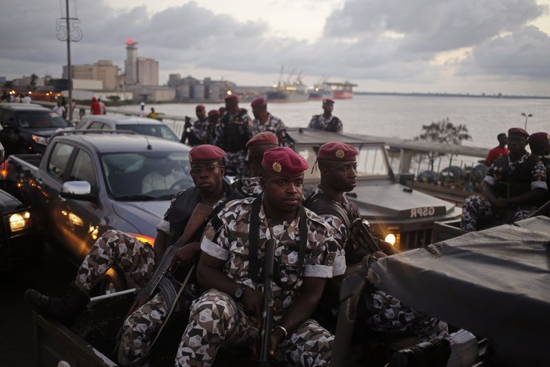 In this file photo taken Friday, Oct. 23, 2015, Ivory Coast troops provide security during an election rally of Ivory Coast incumbent President Alassane Ouattara in Abidjan, Ivory Coast. 
