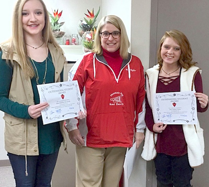 Submitted photo Mountain Pine High School Principal Denise Taylor, center, recently congratulated Caitlyn Beckwith, left, and Audrey Dailey, who were selected as two of the school's recipients of the Outstanding Student Awards for December.