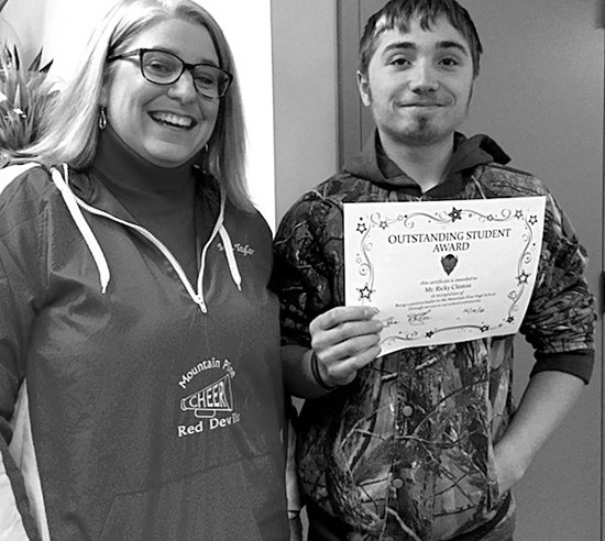 Submitted photo Mountain Pine High School student Ricky Clinton, right, was recently congratulated by Principal Denise Taylor for receiving one of the school's Outstanding Student Awards for December.