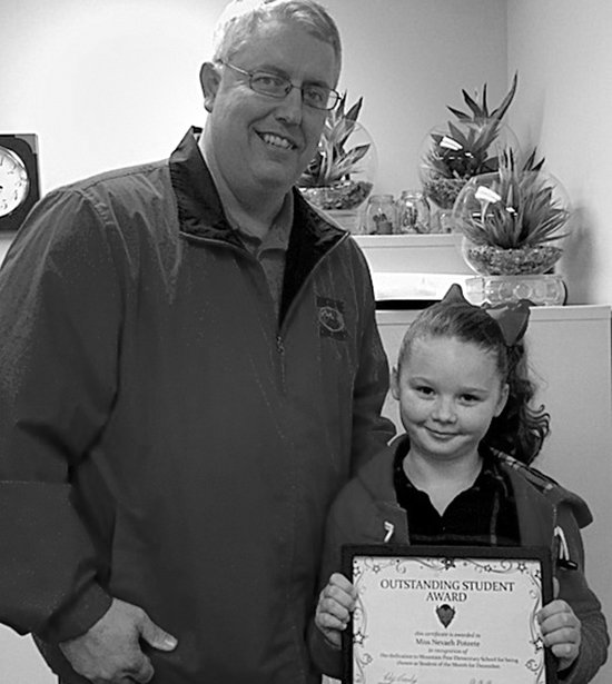 Submitted photo Mountain Pine Elementary School Principal Toby Crosby, left, recently congratulated Nevaeh Poteete for receiving the school's Outstanding Student Award for December.