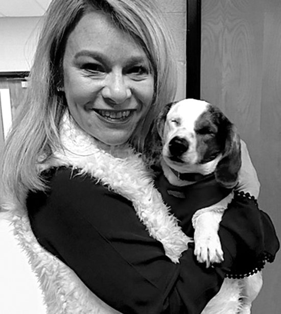 Submitted photo Lakeside Middle School Principal Jamie Preston recently befriended a blind dog rescued by the Humane Society of Garland County. Students volunteered at the Humane Society for the school's annual Day of Caring and met a number of dogs ready for adoption.