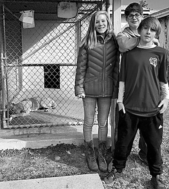 Submitted photo Lakeside Middle School students, from left, Lilly Eye, James Newman and Jonathan Harrison fed dogs and volunteered at the Humane Society of Garland County during the school's recent Day of Caring. Students volunteered for multiple nonprofits throughout the community.