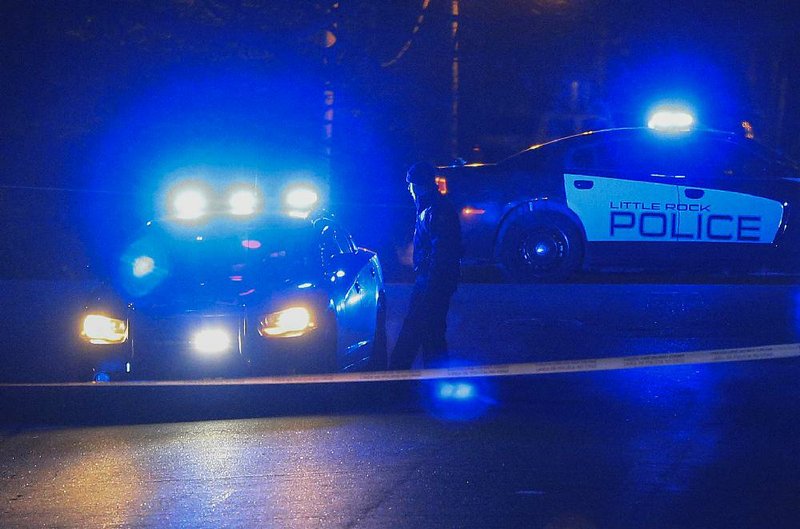 Police block the intersection of West 34th Street and Martin Luther King Drive on Jan. 8 as they investigate a fatal shooting, Little Rock’s first homicide of the year.