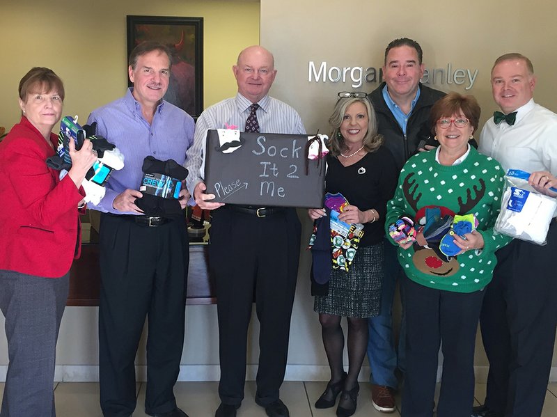 The Morgan Stanley office collected socks for the Ouachita Children's Center and for The CALL, Children of Arkansas are Loved for a Lifetime. From left are Denise Franks, Brad Hudgens, Robert Walker, Debby Butler, Brad Jolly, Susan Goltz Siegel and Dennis Berry. Not pictured are Tina Smoot-Donoho, Mike Adamkiewicz, John Adamkiewicz and Landon Trusty. Morgan Stanley Wealth Management is located at 4262 Central Ave. Suite A. For information, call 501-622-3209. Submitted photo