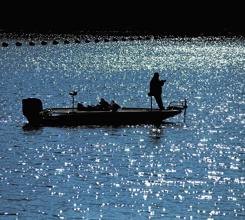 In this file photo an angler spends time fishing in front of Carpenter Dam on Lake Hamilton. 