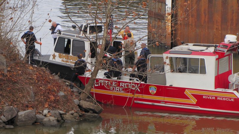 Members of the Pulaski County sheriff's office and Little Rock Fire Department investigate after a body was found in the Arkansas River on Tuesday, Jan. 10, 2017.
